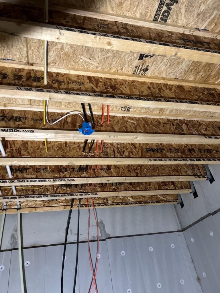 Professional electrician installing overhead electrical wiring Melby Electric